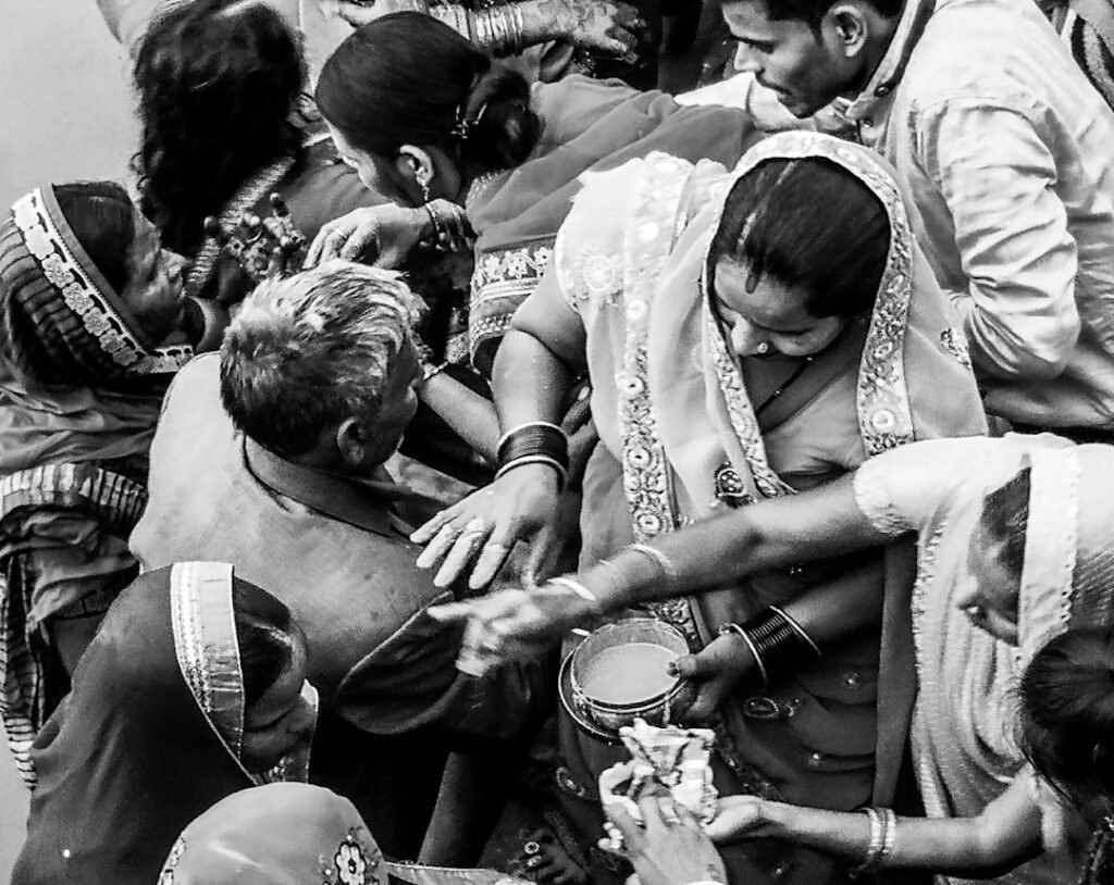 A family gathered around a newborn during a traditional birth or welcoming ceremony
