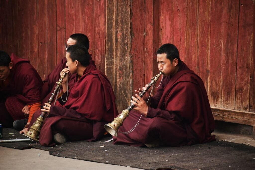 A Buddhist practitioner making a full-body prostration in a monastic or pilgrimage setting