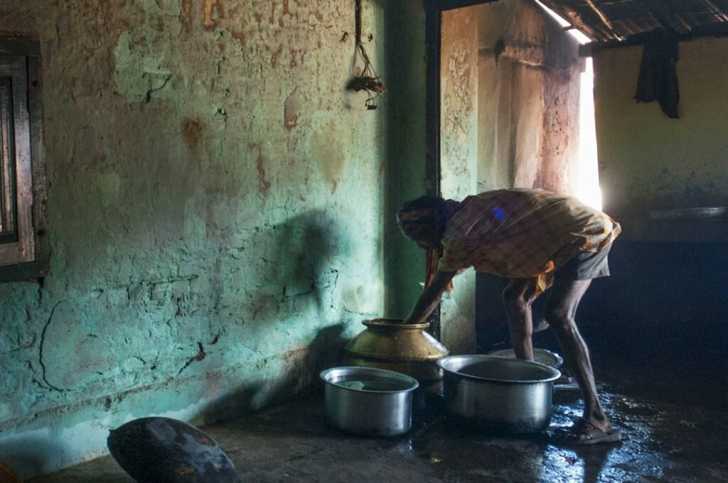 A household entrance being swept or washed in the morning as part of daily domestic practice