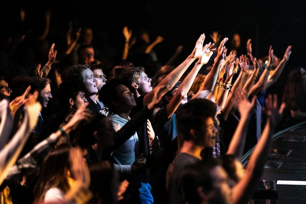People singing together in a worship setting, illustrating the social and ritual role of sacred song