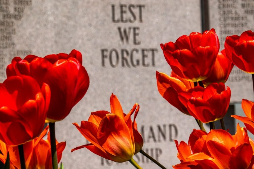 Flowers and candles at a cemetery during a communal day of remembrance