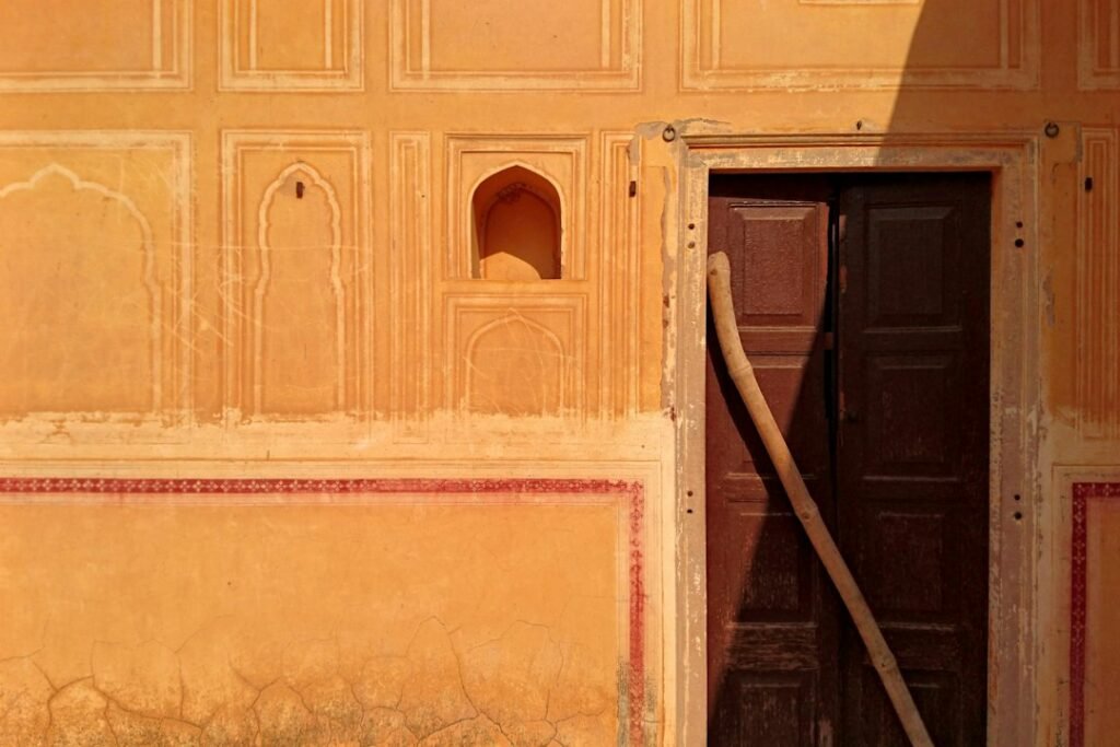 A traditional house oriented toward a strong horizon or sunrise direction, illustrating cultural rules about beds, doors and buildings