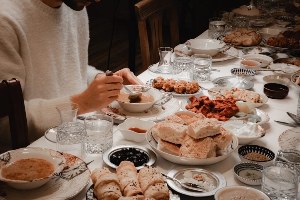 A host serving a guest a meal in an Indian home, illustrating hospitality expressed through food