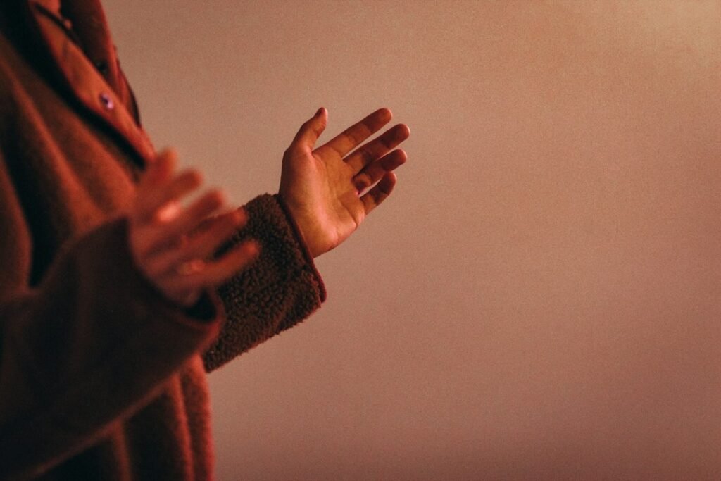 A person's hands folded together in prayer