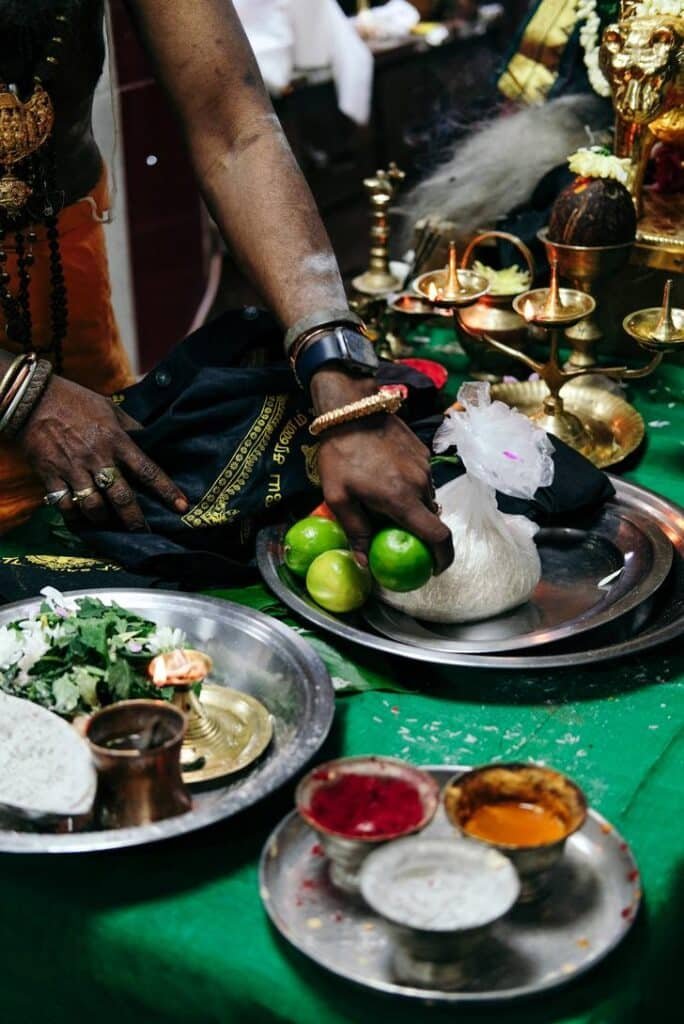 Offerings of fruit, powders and ritual items arranged during a Hindu puja ceremony