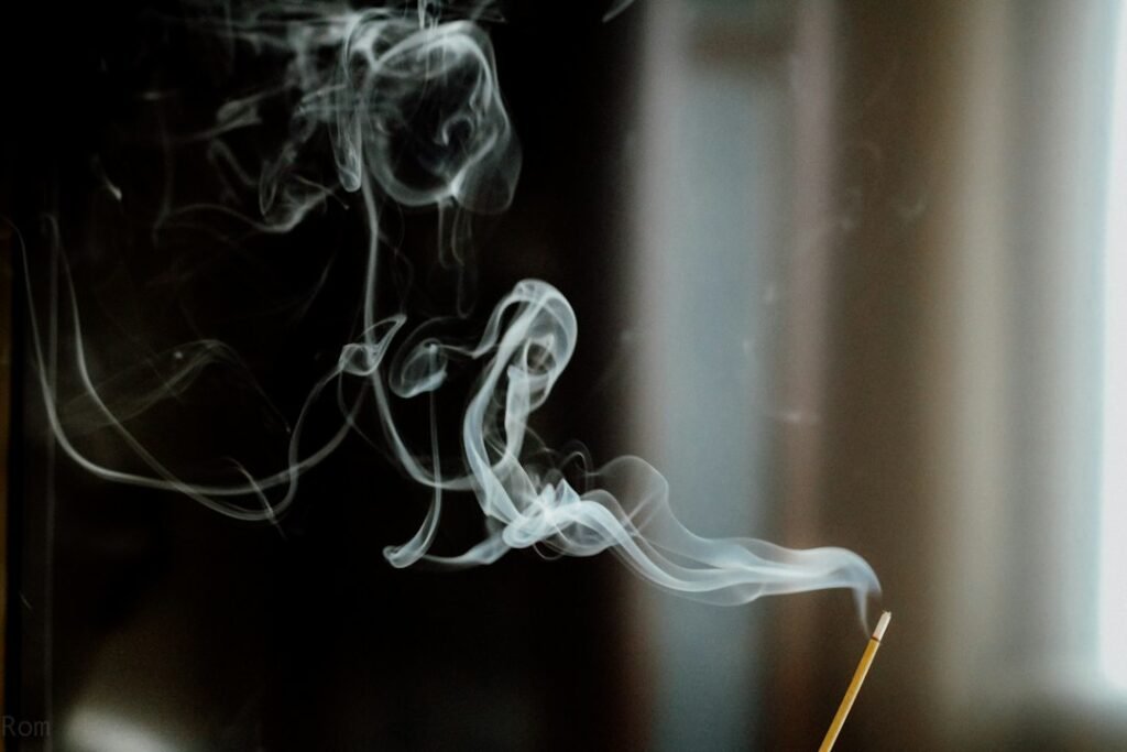 Incense burning in a place of worship, with smoke rising from the ritual vessel