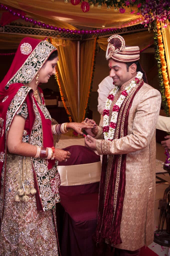 Bride and groom exchanging rings during an Indian Hindu wedding ceremony