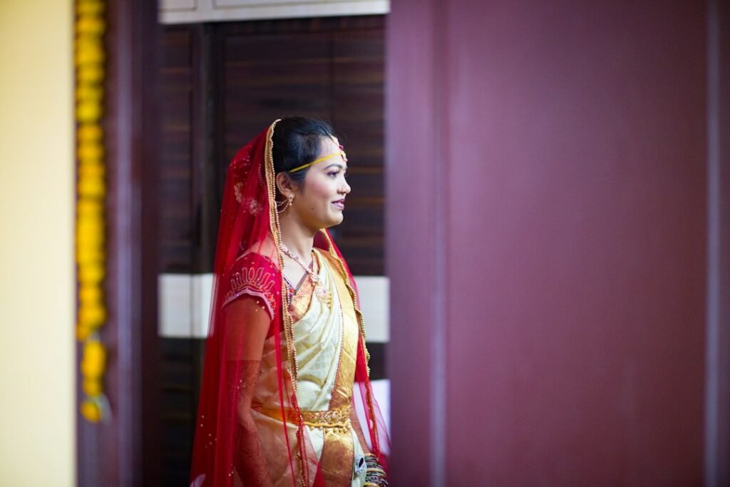 An Indian wedding and domestic threshold context representing changes in dress, name or household after marriage