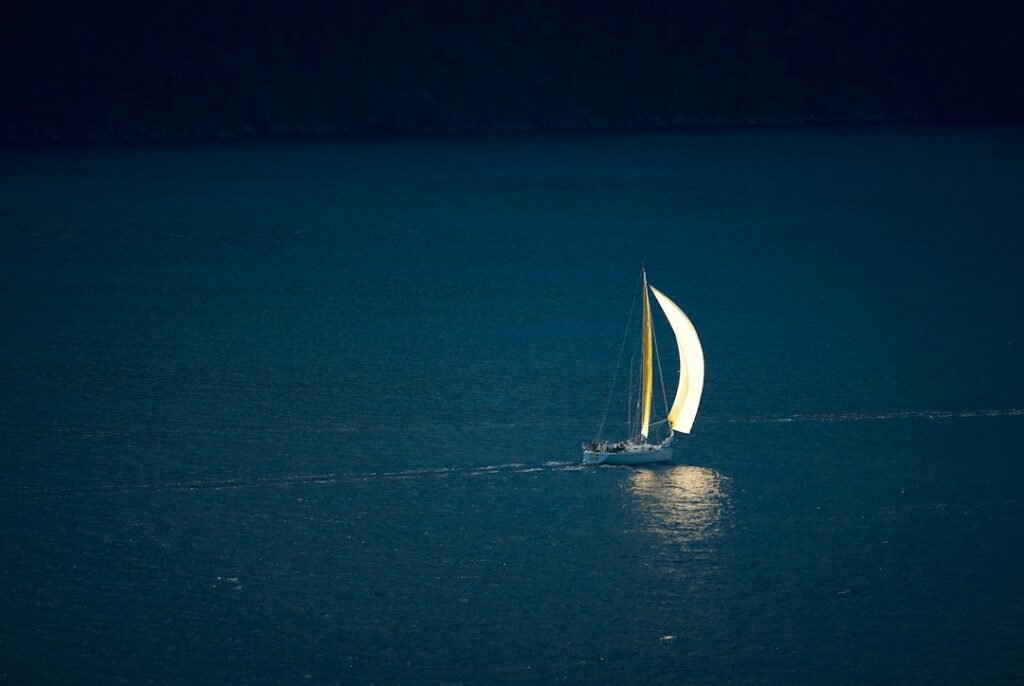 A traditional sailing vessel under a starry night sky, representing celestial navigation