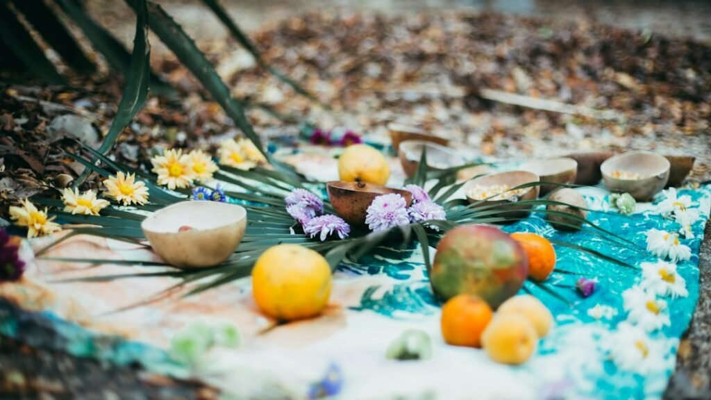 Flowers, food or light placed as an offering at a sacred shrine or altar