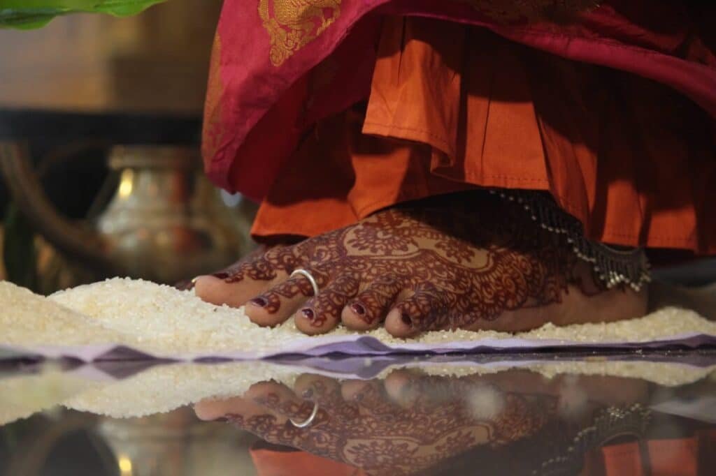 Bride taking a Saptapadi step during a Hindu wedding ritual