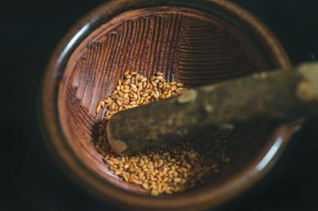 Roasted sesame seeds in a wooden bowl; sesame oil is one of the edible oils traditionally associated with oil pulling