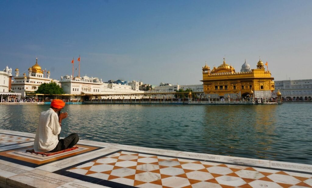Sikh musicians performing Gurbani kirtan in a gurdwara setting